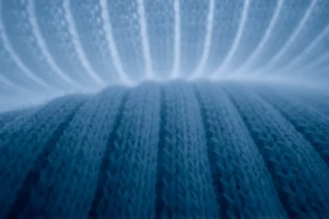 Macro texture of light blue knitted fabric with ribbed wave pattern Stock Photos