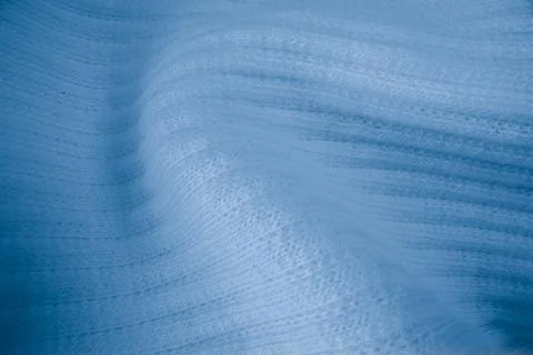 Macro texture of light blue knitted fabric with ribbed wave pattern Stock Photos