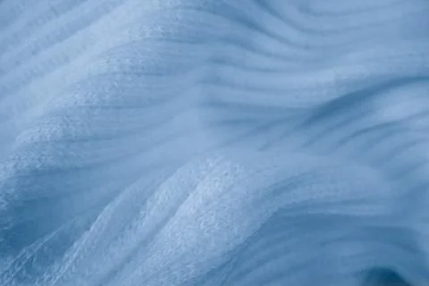 Macro texture of light blue knitted fabric with ribbed wave pattern Stock Photos