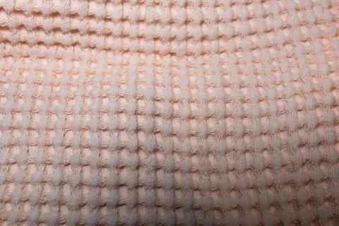 Macro texture of light orange fabric threads background with selective focus and Stockfoto's
