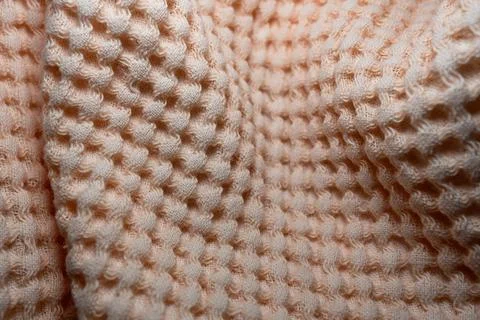 Macro texture of light orange fabric threads background with selective focus and Stock Photos