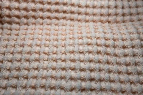 Macro texture of light orange fabric threads background with selective focus and Stock Photos