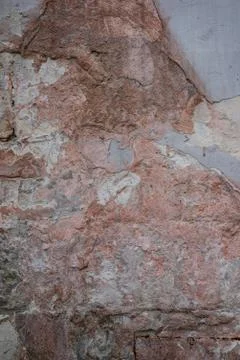 Macro texture of an old red brick wall and even separation of fallen plaster Stock Photos