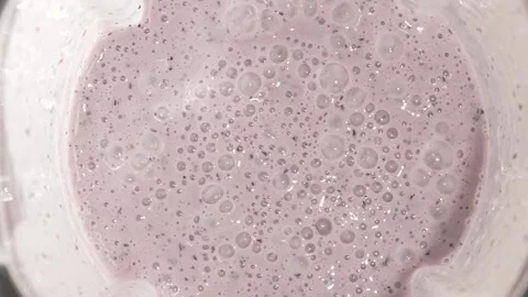 Macro texture of pink berry smoothie with visible air bubbles. Smooth cream.. Stock Footage 315033416