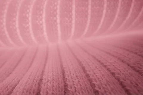 Macro texture of pink knitted wool fabric with ribbed pattern Stock Photos