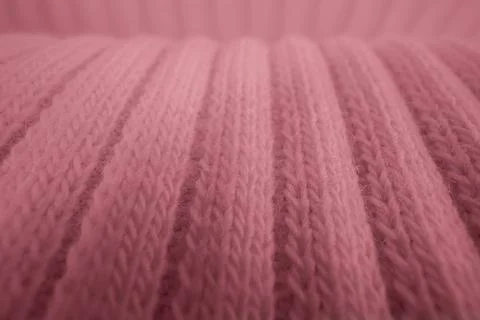Macro texture of pink knitted wool fabric with ribbed pattern Stock Photos