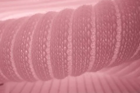 Macro texture of pink knitted wool fabric with ribbed pattern Stock Photos