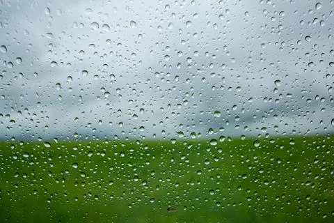 Macro texture of raindrops on window glass. in the background a cloudy sky af Stock Photos