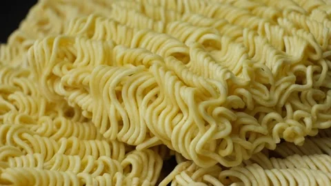 Macro texture of raw instant ramen noodles slowly rotating Stock Footage 346883820