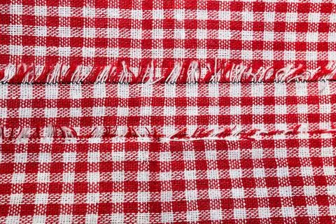 Macro texture of red and white fabric threads background with selective focus Stock Photos