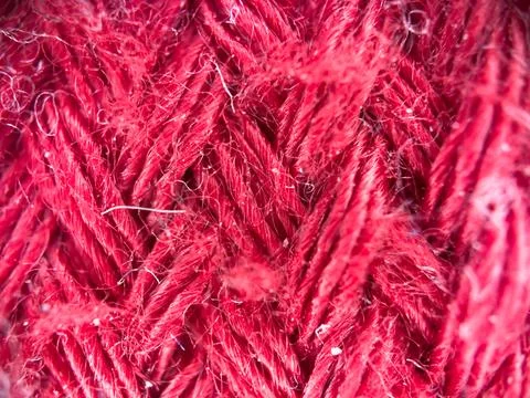 Macro texture of red fabric threads, close up background with selective focus Stock Photos