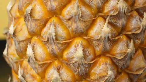 Macro texture of ripe pineapple rind rotating in close up Stock Footage 336615181