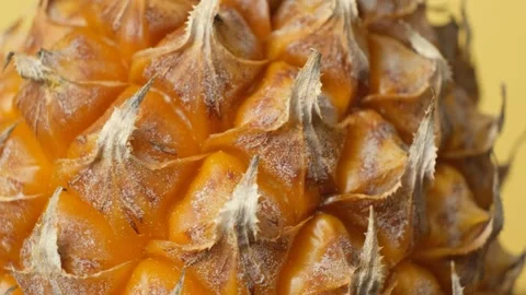 Macro texture of ripe pineapple rind rotating in close up Stock Footage 337700391