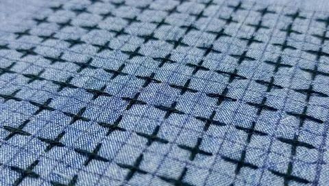 Macro texture of sashiko embroidery pattern on blue fabric Foto stock