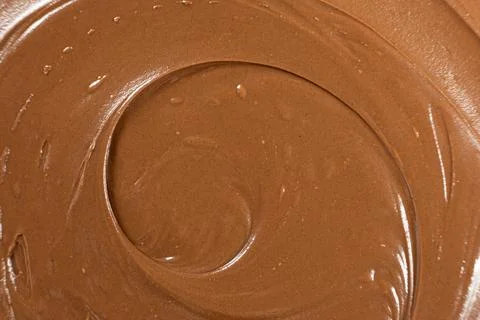Macro texture of smooth brown chocolate nut spread swirl Fotos Stock