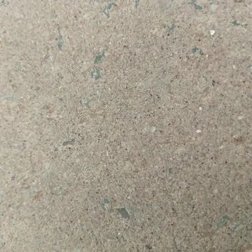 Macro texture of smooth grey concrete surface with embedded small stones Stock Photos