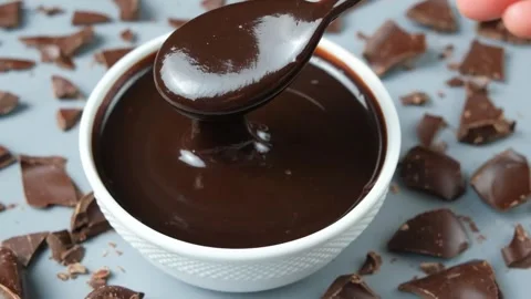 Macro texture of smooth melting chocolate sauce flowing Stock Footage 335836232