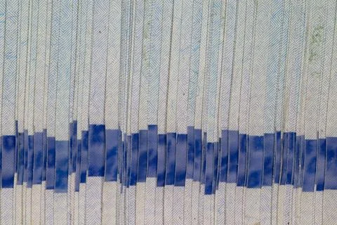 Macro texture of a stack of new banknotes with blue security holographic ri.. Stock Photos