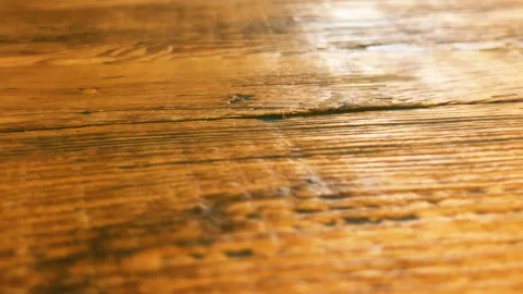 Macro texture of treated hardwood table surface in cafe interior Stock Footage 320827024