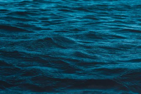 Macro texture of the water surface, blue sea waves. Stock Photos