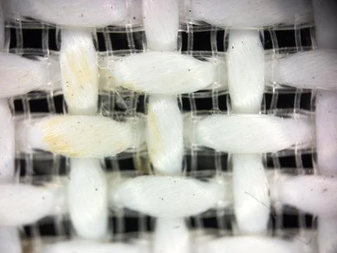 Macro texture of white fabric threads, close up background with selective focus Stock Photos