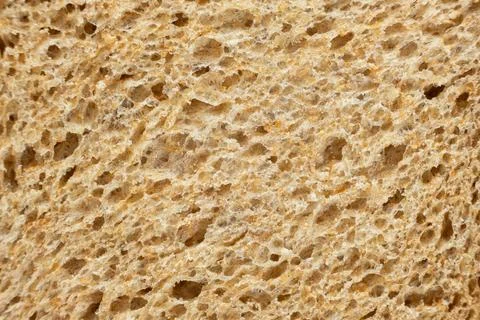 Macro texture of whole wheat bread crumb, detailed food background. 写真素材