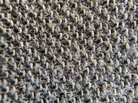Macro texture of wool knitted fabric. Knitted background. Stock Photos