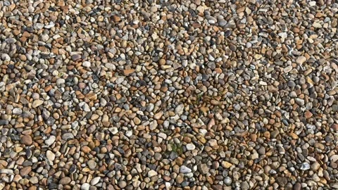Macro textured garden pebble surface aerial Stock Footage 330743472