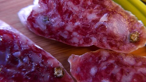 Macro of thin slices of salami on the dish. 4K UHD 動画素材 73048330