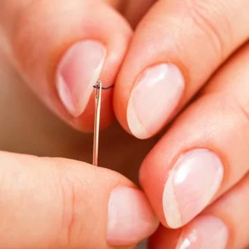 Macro of threading a needle Stock Photos