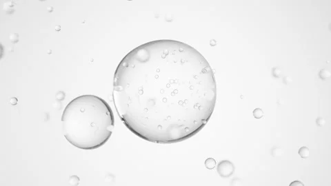 Macro of three drops of transparent liquid merge into one with bubbles inside on Stock Footage 276896805