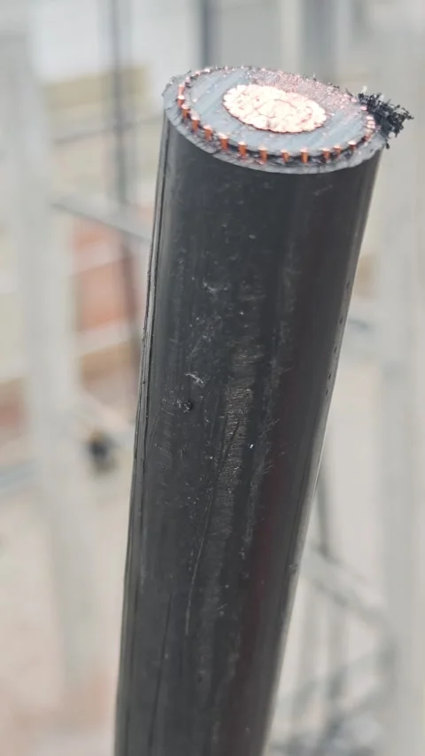 Macro tilt down video of high voltage underground copper power cable from c.. Stock-Footage 338017538
