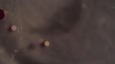 Macro tiny clear bubbles and red splatters moving through liquid texture Video stock 118280360