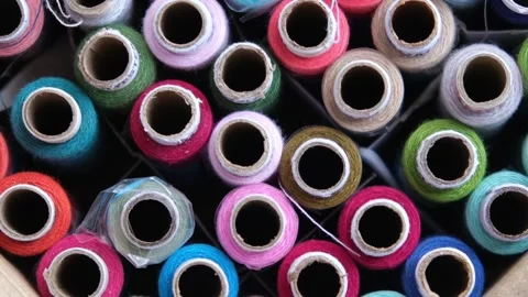 Macro top view of colorful polyester sewing thread spools organized together Stock Footage 329370167