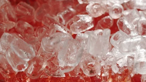 Macro top view of ice cubes in slow motion flying up with raspberry water Stock Footage 117407233