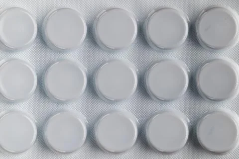 Macro top view of white blister pack with round medicine pills Stock Photos