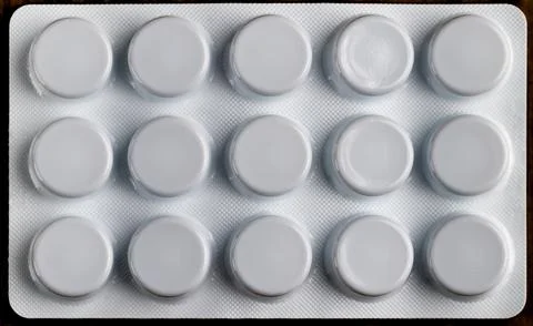 Macro top view of white blister pack with round medicine pills Stock Photos