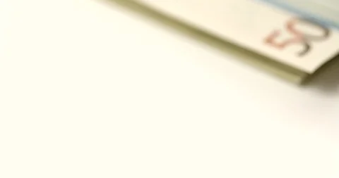 A macro tracking shot across a stack of Euro Notes Stock Footage 88487881