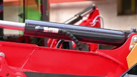 Macro tracking shot of a chrome hydraulic piston rod on heavy machinery. Stock Footage 338432584