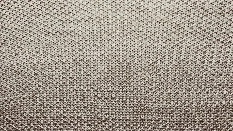 Macro tracking shot shifts focus across authentic textured beige wool knit fabri Stock Footage 337550348