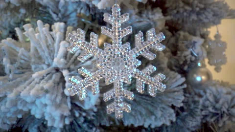 Macro tracking shot of a white Christmas tree with balls and snowflakes Stock Footage 220084162