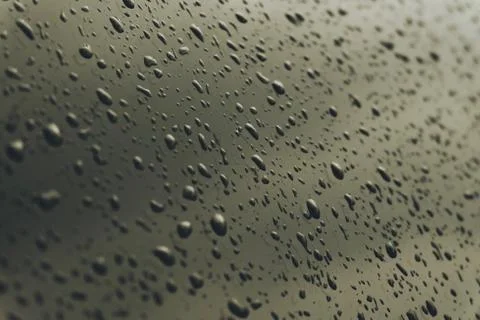 Macro transparent dew drop on mirror. Close-up of rain water. Moody tone. Stock Photos