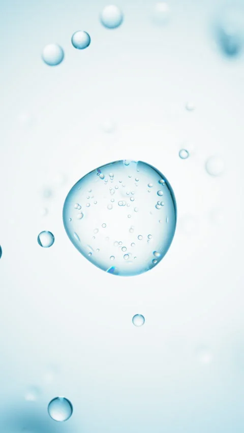 Macro of transparent drop of blue liquid with bubbles inside on blue backdrop Stock Footage 323122592