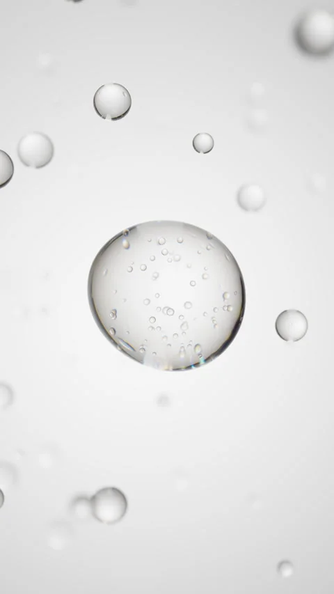 Macro of transparent drop of liquid with bubbles inside on white backdrop. Skin Stock Footage 323121540