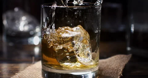 Macro of transparent fresh cool ice bounced by bartender in whiskey cocktail Stock Footage 269934453