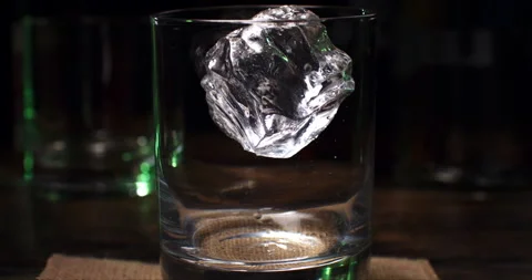 Macro of transparent fresh cool ice bounced by bartender in whiskey cocktail Stock Footage 270044659