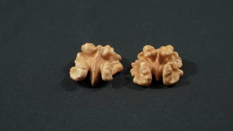 Macro Two Shelled Walnut Halves Rotating Black Background Stockbeeldmateriaal 332523326