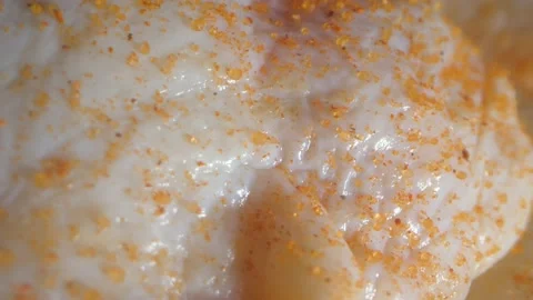 Macro ultra close up raw chicken thighs seasoned in slow motion Stock Footage 164007078