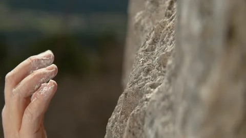 MACRO: Unrecognizable rock climber with chalked up hands grips a sloper hold. Stock Footage 135083365