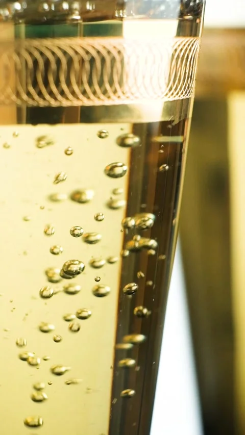 Macro vertical shooting of white wine in glass, bubbles slow motion Stock Footage 329550119